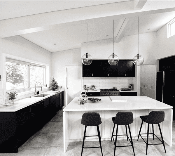 A minimalist kitchen with black and white color scheme.