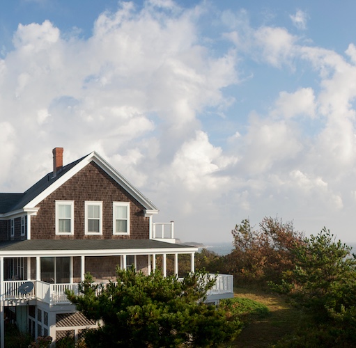 Classic east coast style home with large covered wrap around porch overlooking ocean views in Rhode Island.