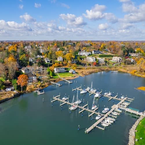 Connecticut bay area showing homes and a marina during the fall.