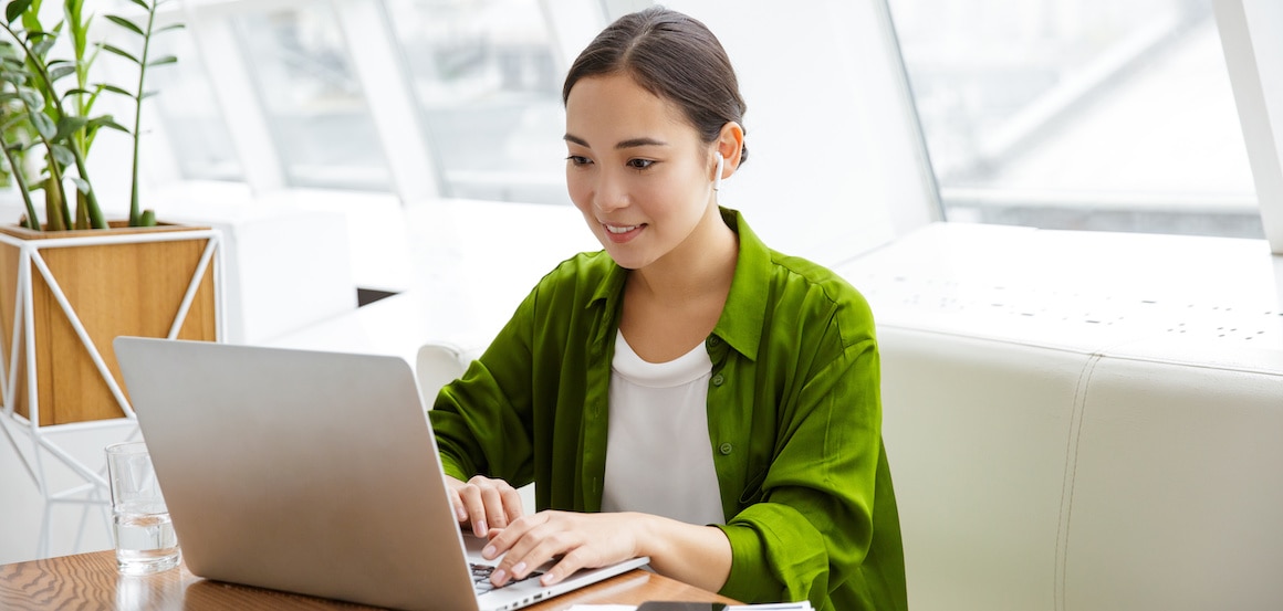 A young woman working on her laptop.