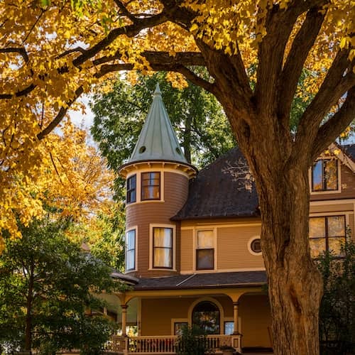 Ornate Victorian style home on W Broadway in Decorah Iowa in autumn. 