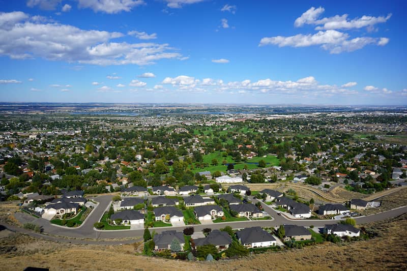 RHB Assets From IGX: Aerial view of the Tri-Cities in Washington State, with a river winding through.