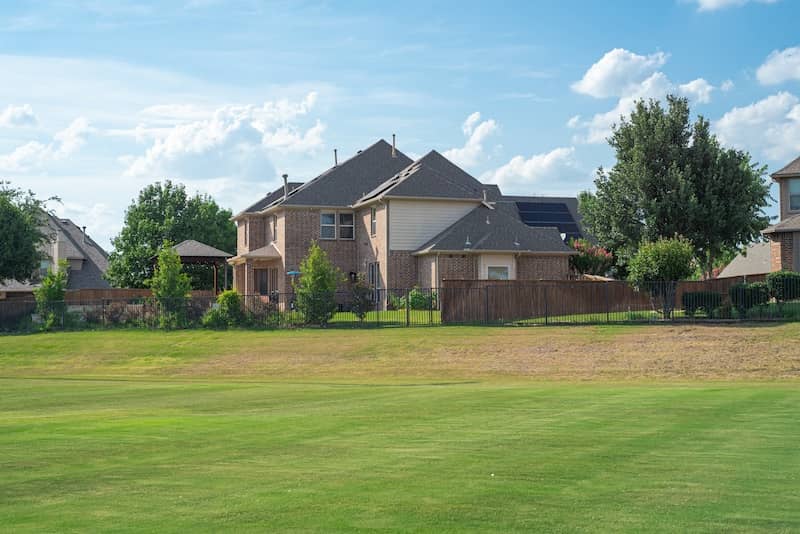 Large grassy lawn of suburban park next to upscale residential neighborhood in Flower Mound, Texas