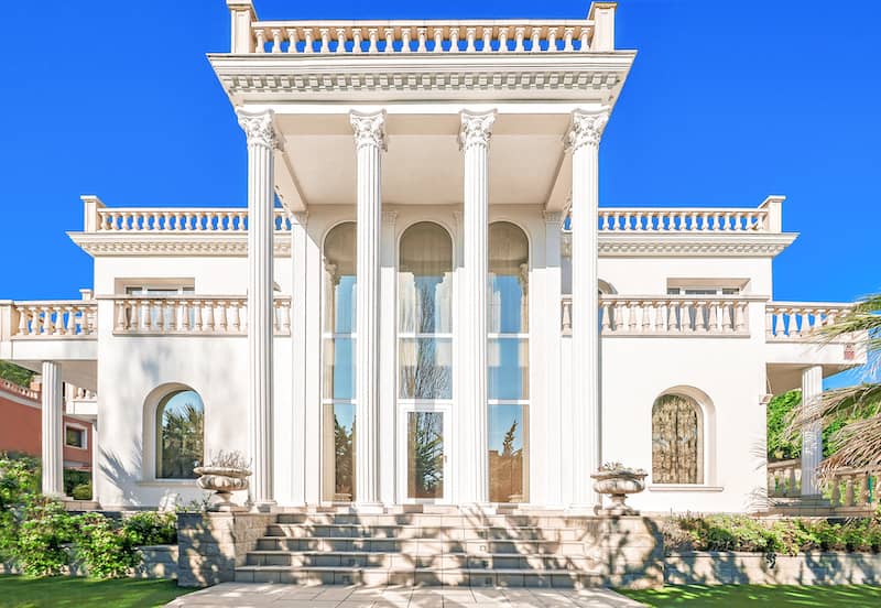 Large luxury white neoclassical style home.