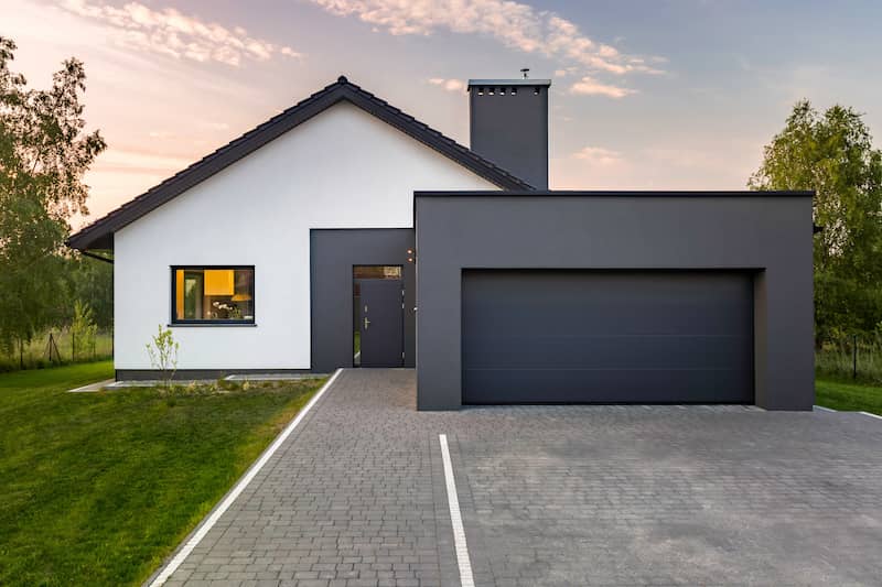 Exterior of a modern house with a garage with a flat roof.