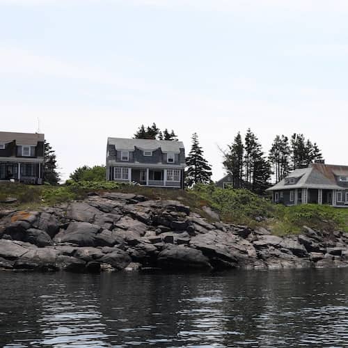 Historic homes along Maine rocky shoreline.