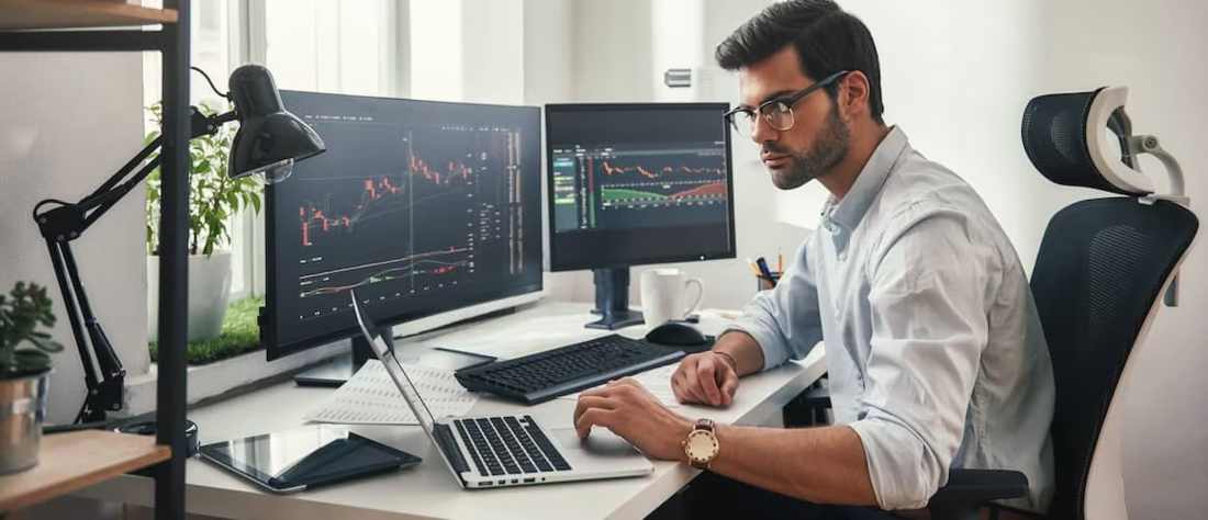 Young businessman looking at stocks at his desk.