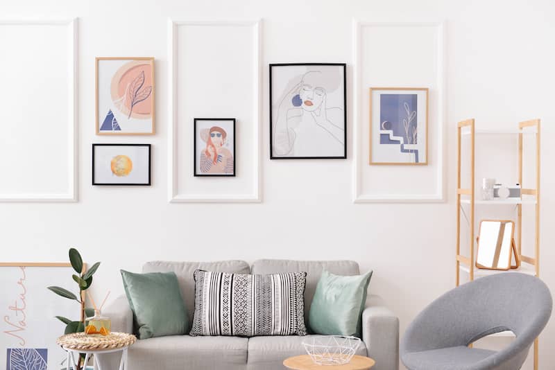 RHB Assets From IGX: A white wall with hanging art pieces in a home office.