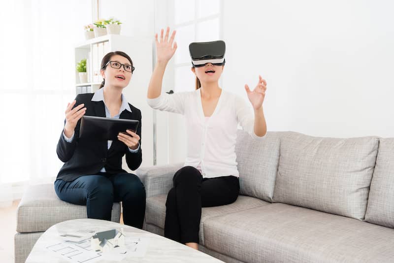 RHB Assets From IGX: Woman sitting on sofa with VR headset