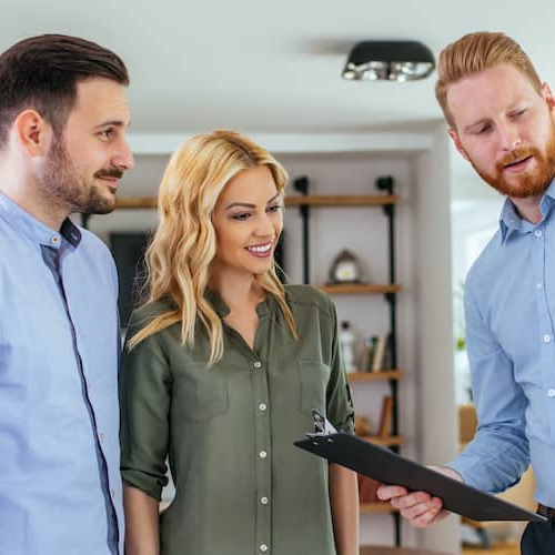 RHB Assets From IGX: A couple with a home appraiser during an inspection.