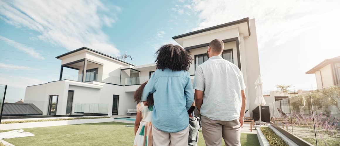A family inspecting or looking at a house, potentially in the context of home buying or renting.