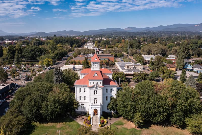 RHB Assets From IGX: Picturesque Corvallis, Oregon with a bridge, river, and surrounding greenery.