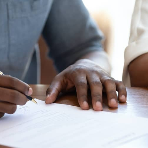 People signing a mortgage note or document.