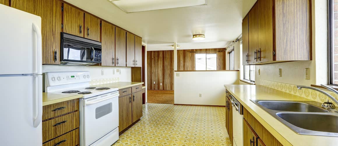 An image of a kitchen with modern appliances in wood style design.