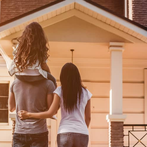 A family looking at a house possibly their own resident.
