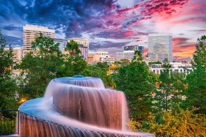 Sunset view of Columbia South Carolina with beautiful fountain in foreground.