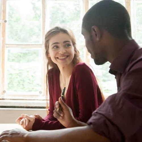 Couple chatting with financial advisor. 