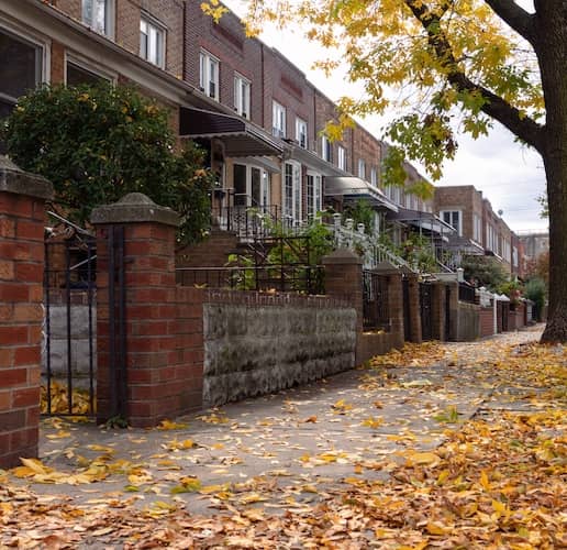 Row of brick townhomes in Astoria, Queens, New York in autumn.