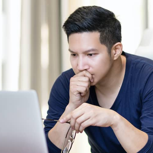 Stressed man holding glasses, indicating potential stress related to homeownership or finances.