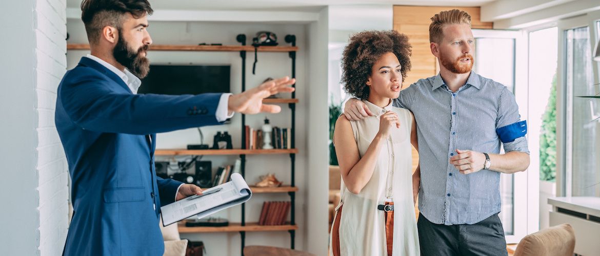 RHB Assets From IGX: Young couple looking at a house with a real estate agent