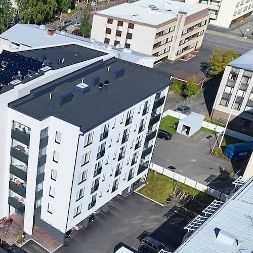 Aerial view of apartment building with solar panels.