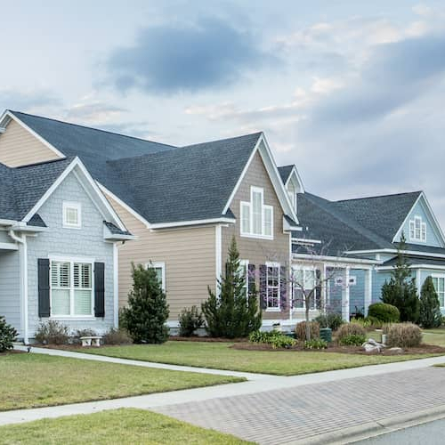 A residential neighborhood with multiple houses, showing a suburban or urban living environment.
