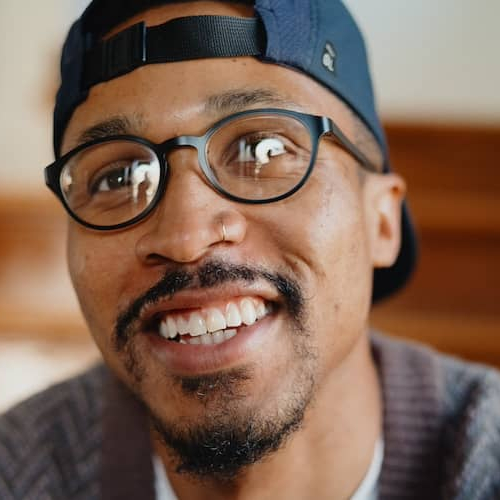 Man sitting on staircase with peaceful and happy look on his face.