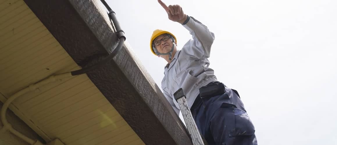 Man inspecting a home, indicating a property inspection process or assessment.