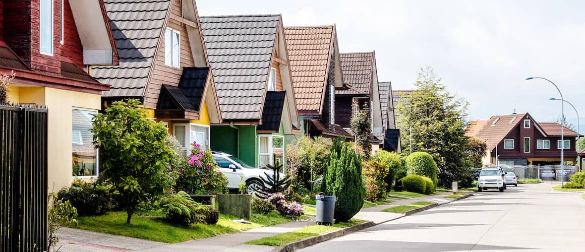 An image of a traditional neighborhood setting, depicting houses in a residential area.