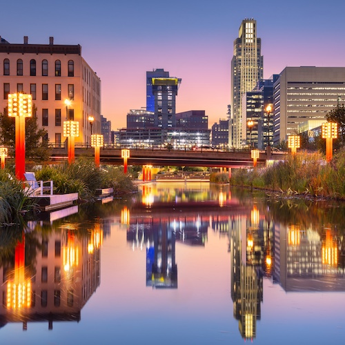 Cityscape of downtown Omaha lit up with orange lights.