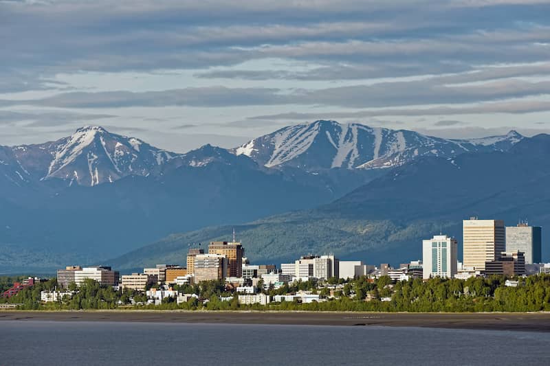 RHB Assets From IGX: Majestic mountain landscape with a hiker overlooking the view near Anchorage, Alaska.