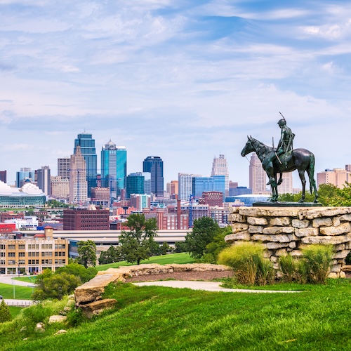 Cityscape of Kansas City, Missouri, with the famous statue of The Scout in the foreground.
