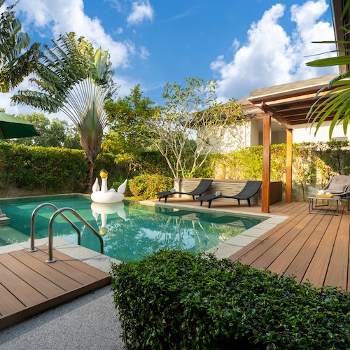 Swan inner tube in private pool with desk and garden at luxury property.