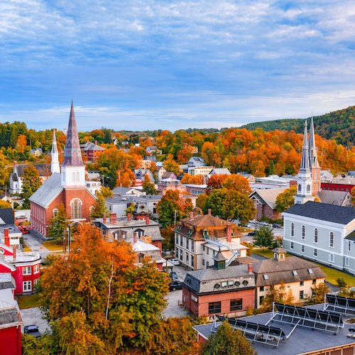 Burlington cityscape of Vermont in autumn with many orange leafy trees.