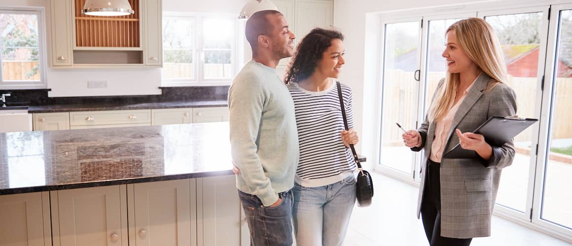 Couple at real estate showing with their Realtor.