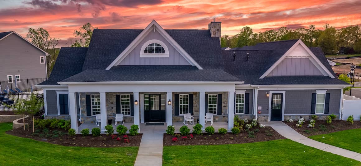 Newly built modern single-family tan home with landscaping, representing construction loans.