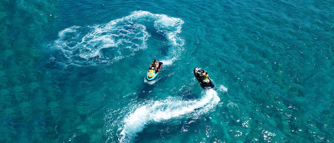 jet skis circling each other in clear blue water