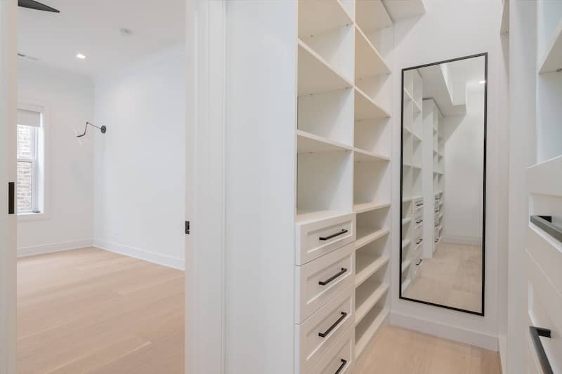 RHB Assets From IGX: Mirrors in a walk-in closet reflecting a stylish wardrobe and accessories.