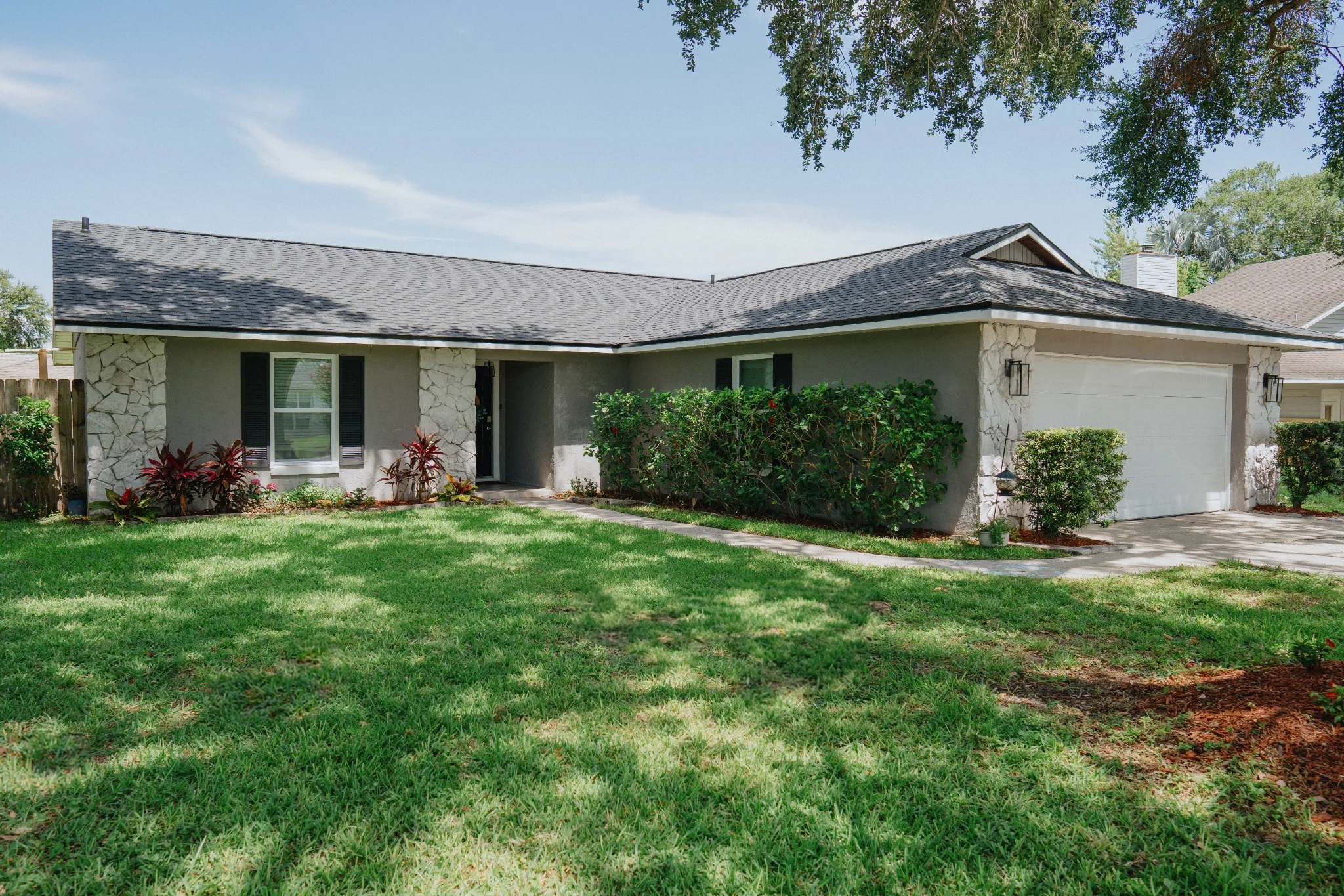 Single-story home with a landscaped front yard and attached garage in a suburban neighborhood