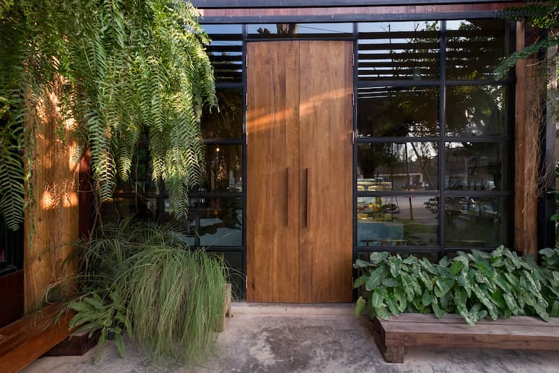 Front door decorated with greenery