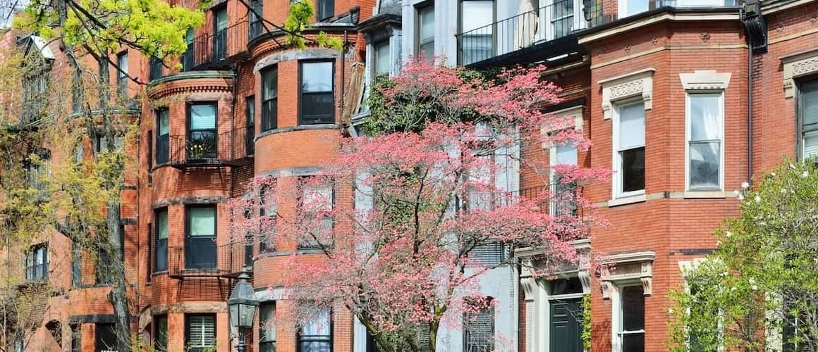 Urban architecture with greenery representing real estate investment.