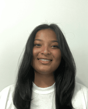 Headshot of a woman with dark hair against a white background.