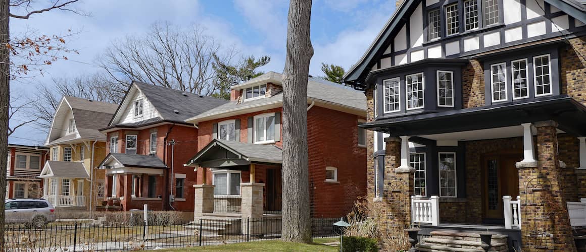 RHB Assets From IGX: Foreclosed home with overgrown yard and boarded windows