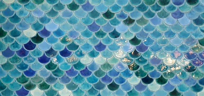 Blue and aquamarine fish scale backsplash.