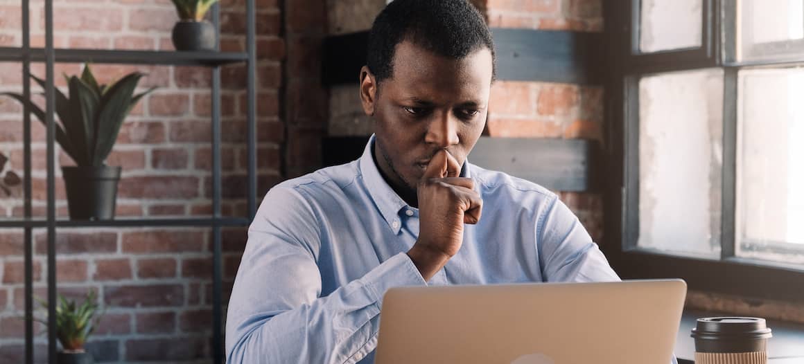 A person in thought, possibly contemplating mortgage or financial decisions.