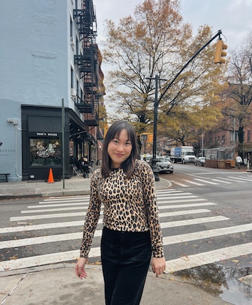 Photo of Darby Mulligan standing in front of a crosswalk and posing for a picture.