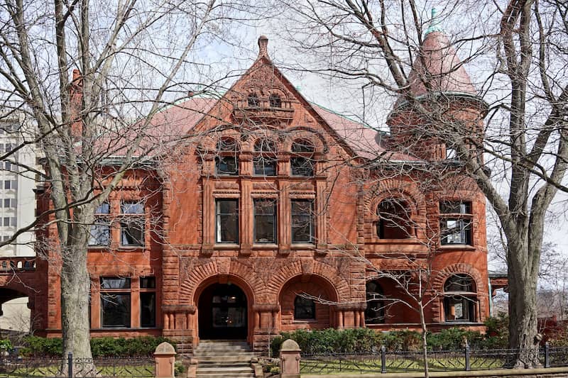 Red brick Romanesque Revival Victorian style mansion.