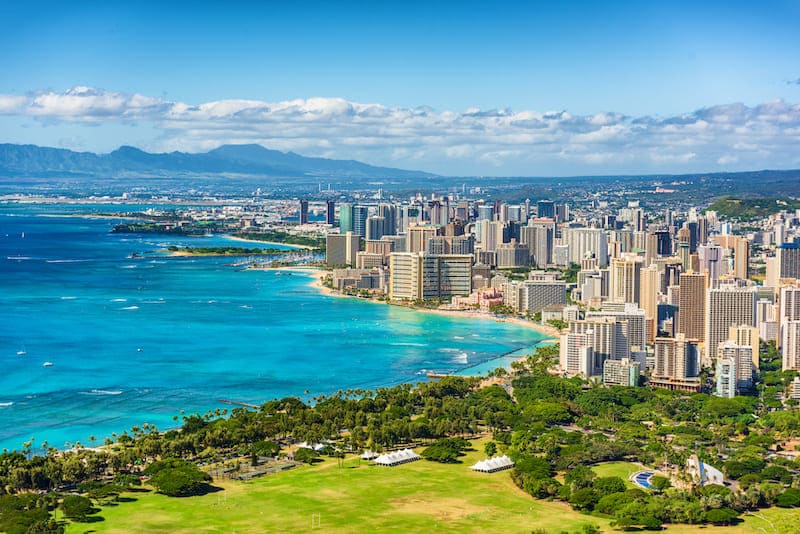 RHB Assets From IGX: Scenic view of a beautiful Hawaiian beach with turquoise waters and palm trees.