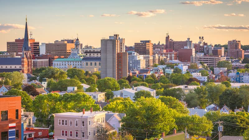 RHB Assets From IGX: Aerial view of Portland, Maine with a cityscape and waterways.