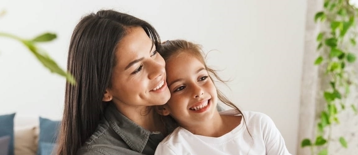 A woman hugging her daughter.